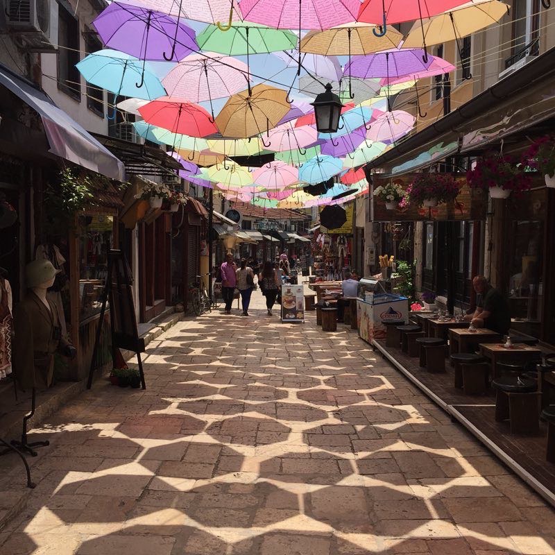 Colorful umbrellas lining a bazaar alley in Skopje, North Macedonia