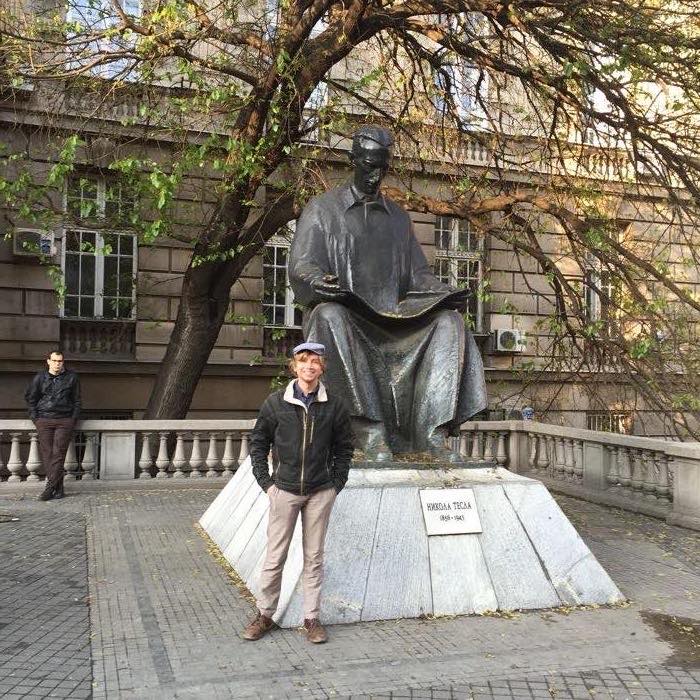 Tom posing next to the Nikola Tesla statue in Belgrade